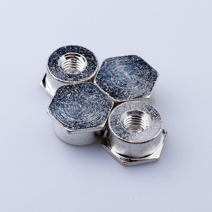 Four tin-plated brass hex nuts