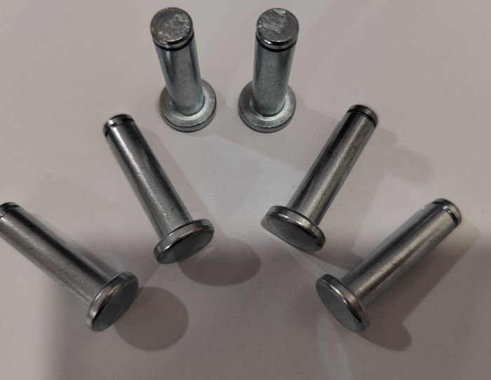 Six flat-head rivets arranged in an arc