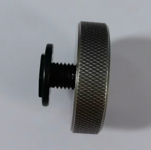 A fine-thread screw stopped partway into a knurled thread ring gauge